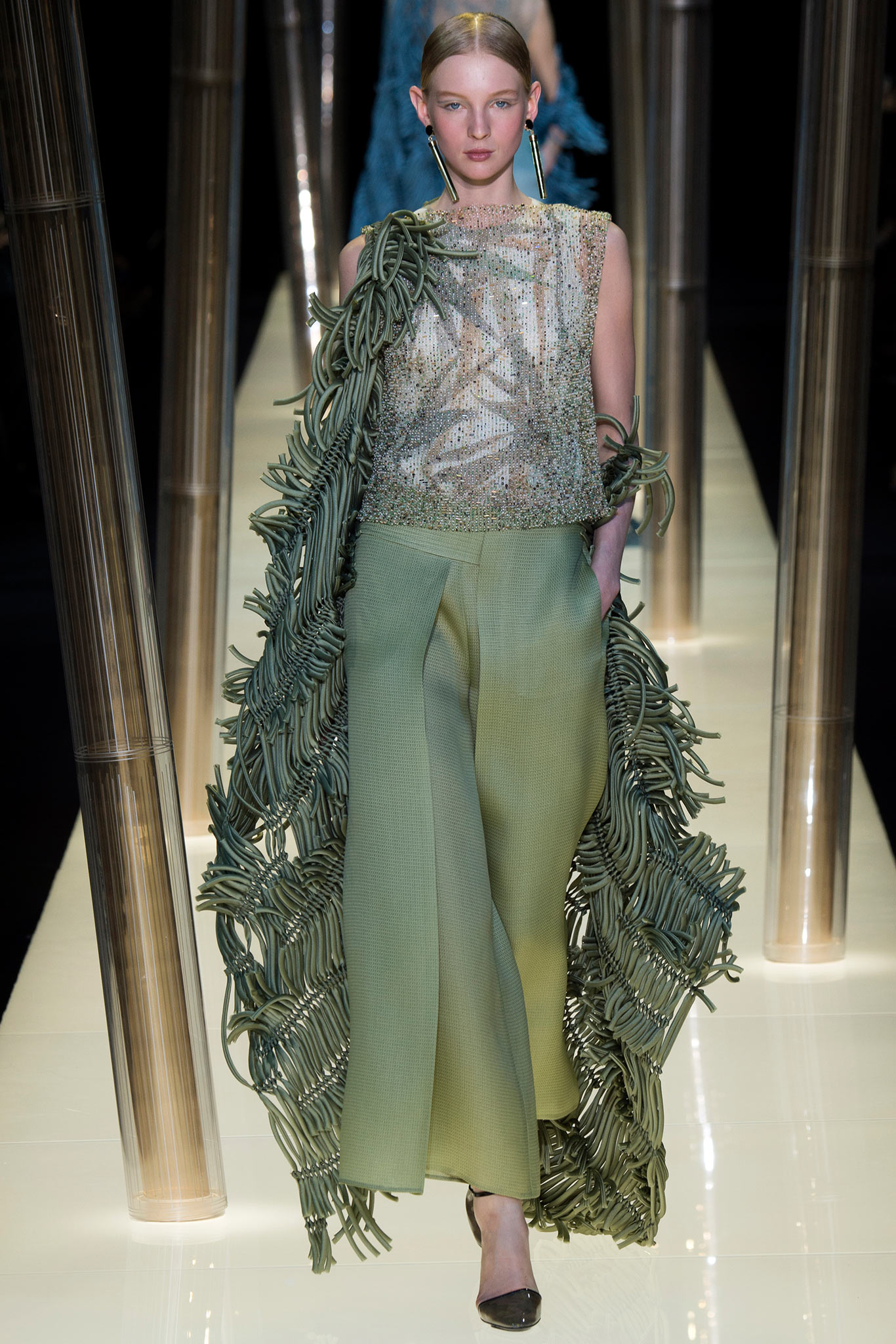 gold ruffled top with green wide-leg pants