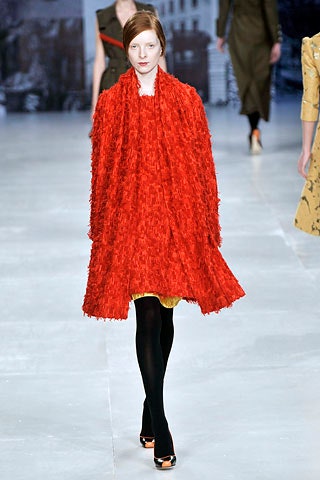 red fringed cape and yellow dress
