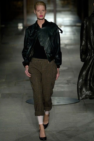 black leather fitted jacket and brown checked pants