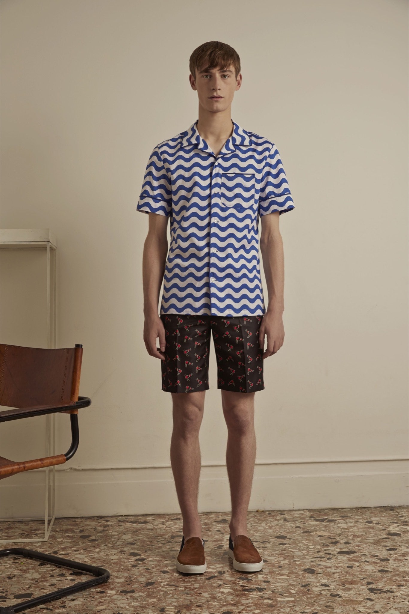 blue and white printed shirt with black shorts