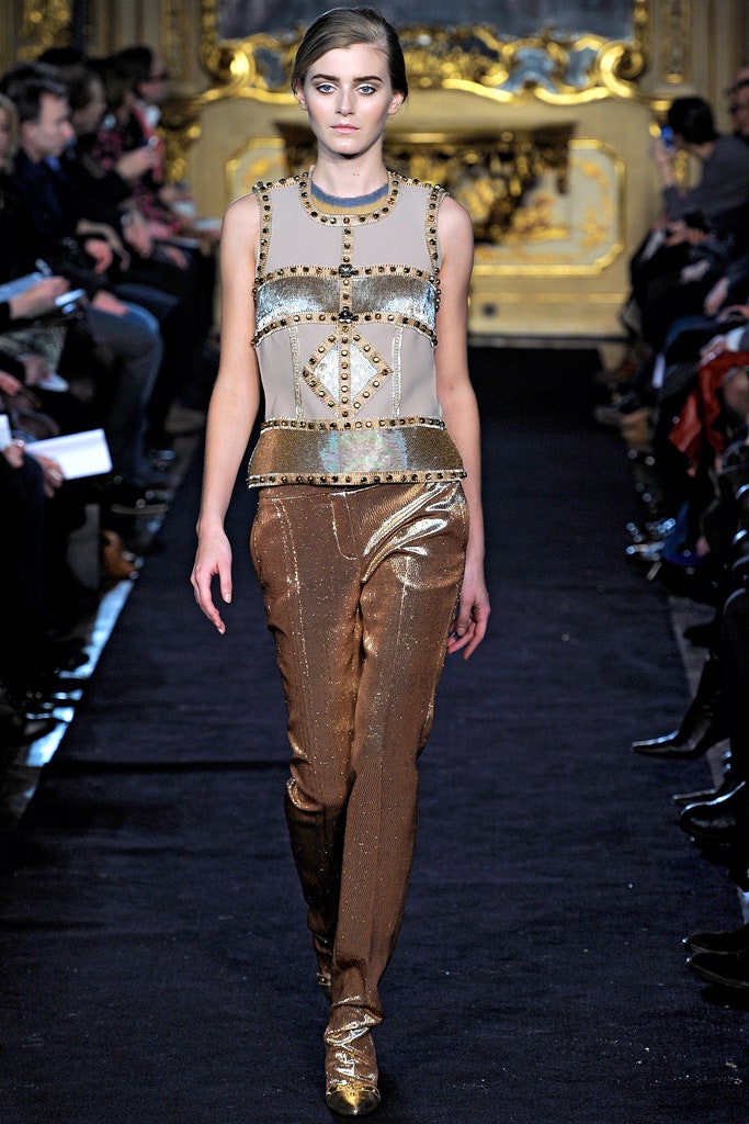 beige embellished sleeveless top and gold slim pants