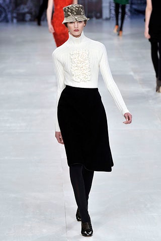 white fitted turtleneck top and black a-line skirt
