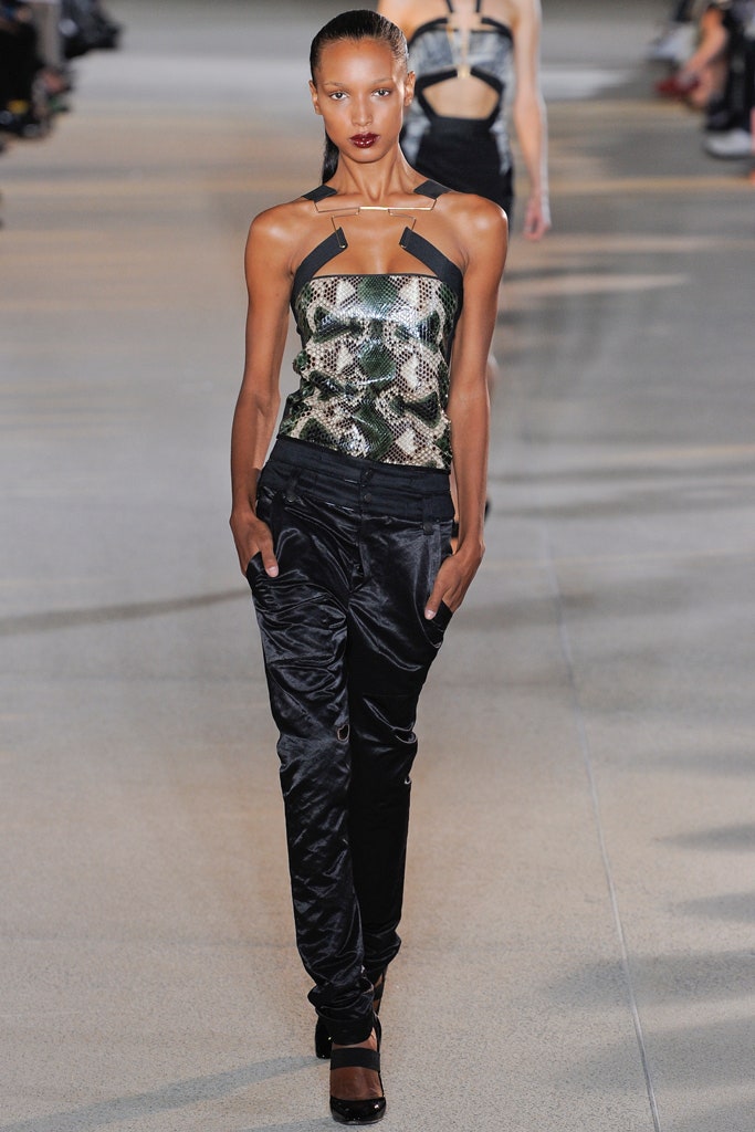 fitted green silk top with relaxed black pants