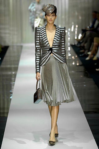 fitted gray silk blazer and pleated skirt
