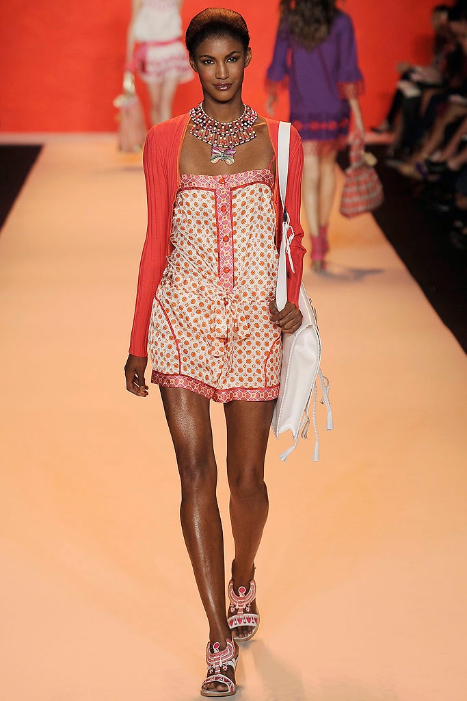 white orange printed romper with red cardigan