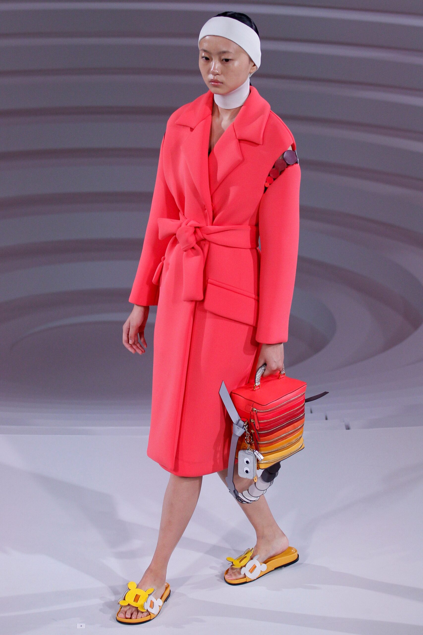 pink belted coat with color-blocked bag