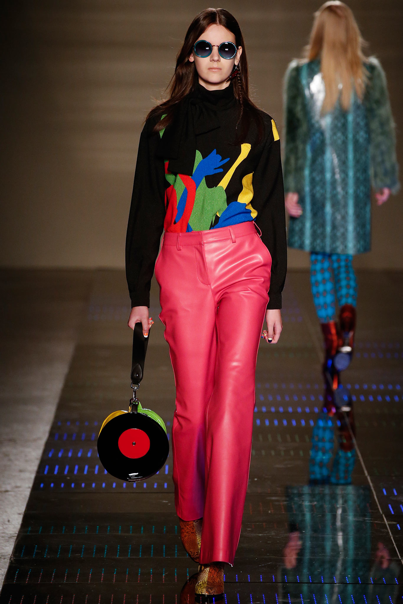 black multi-printed fitted top and pink leather pants