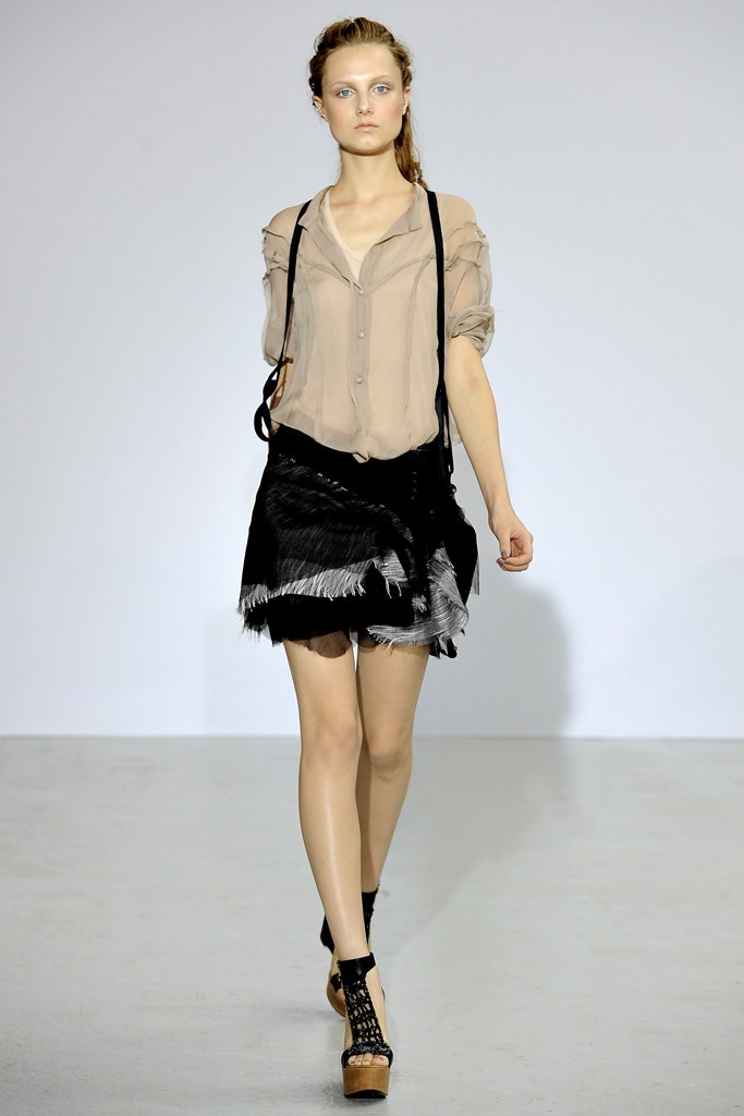 beige relaxed shirt with black pleated skirt