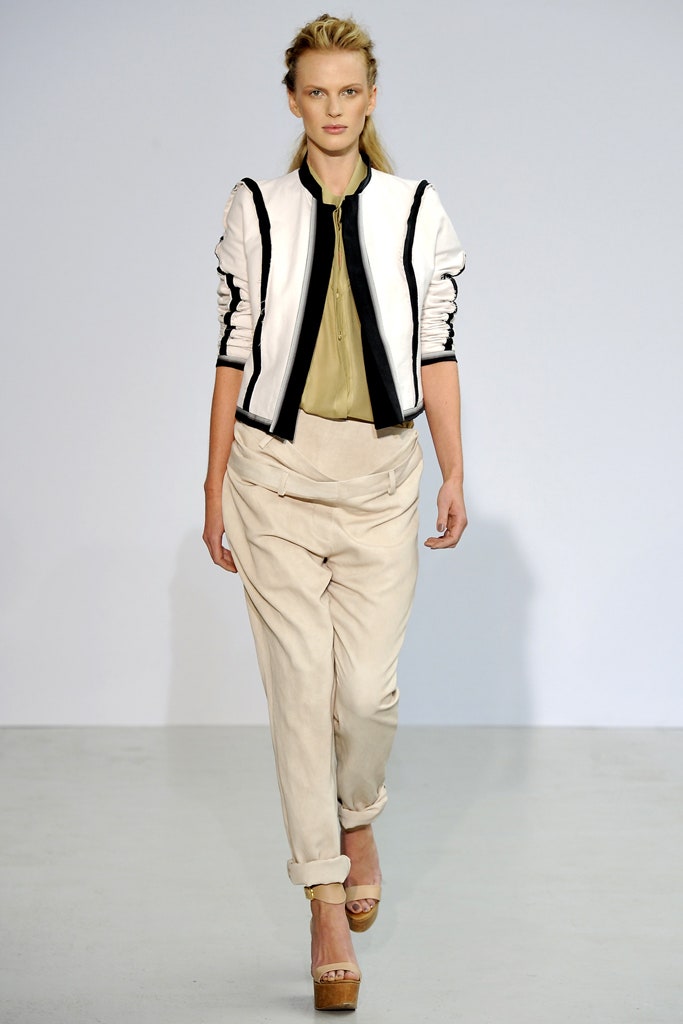 fitted black and white jacket with relaxed green shirt