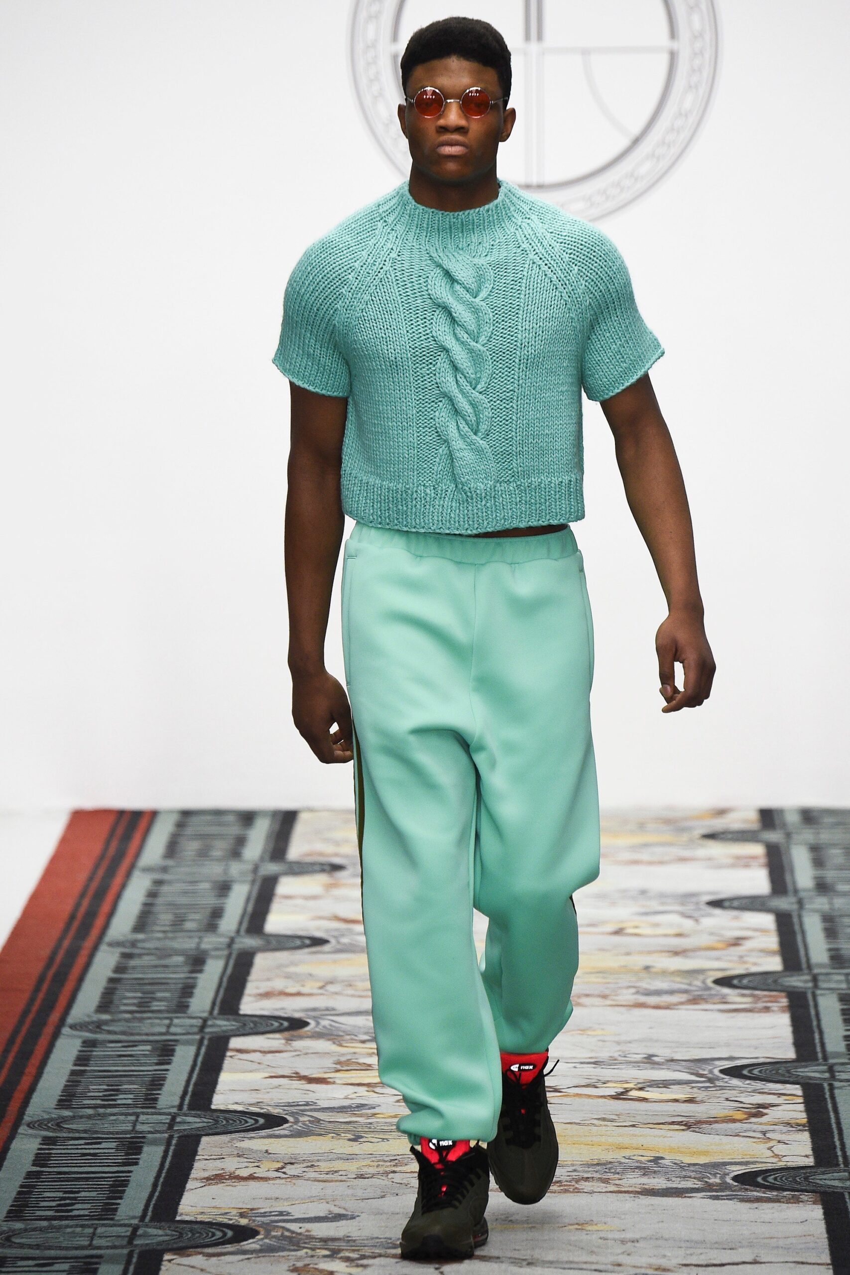 blue cropped knitted sweater with green pants