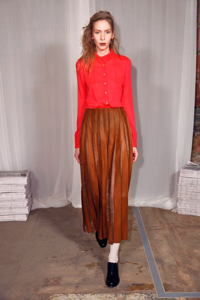 red fitted shirt with brown pleated skirt