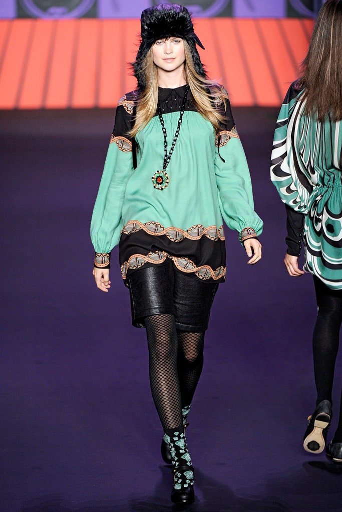 green silk mini dress with black hat