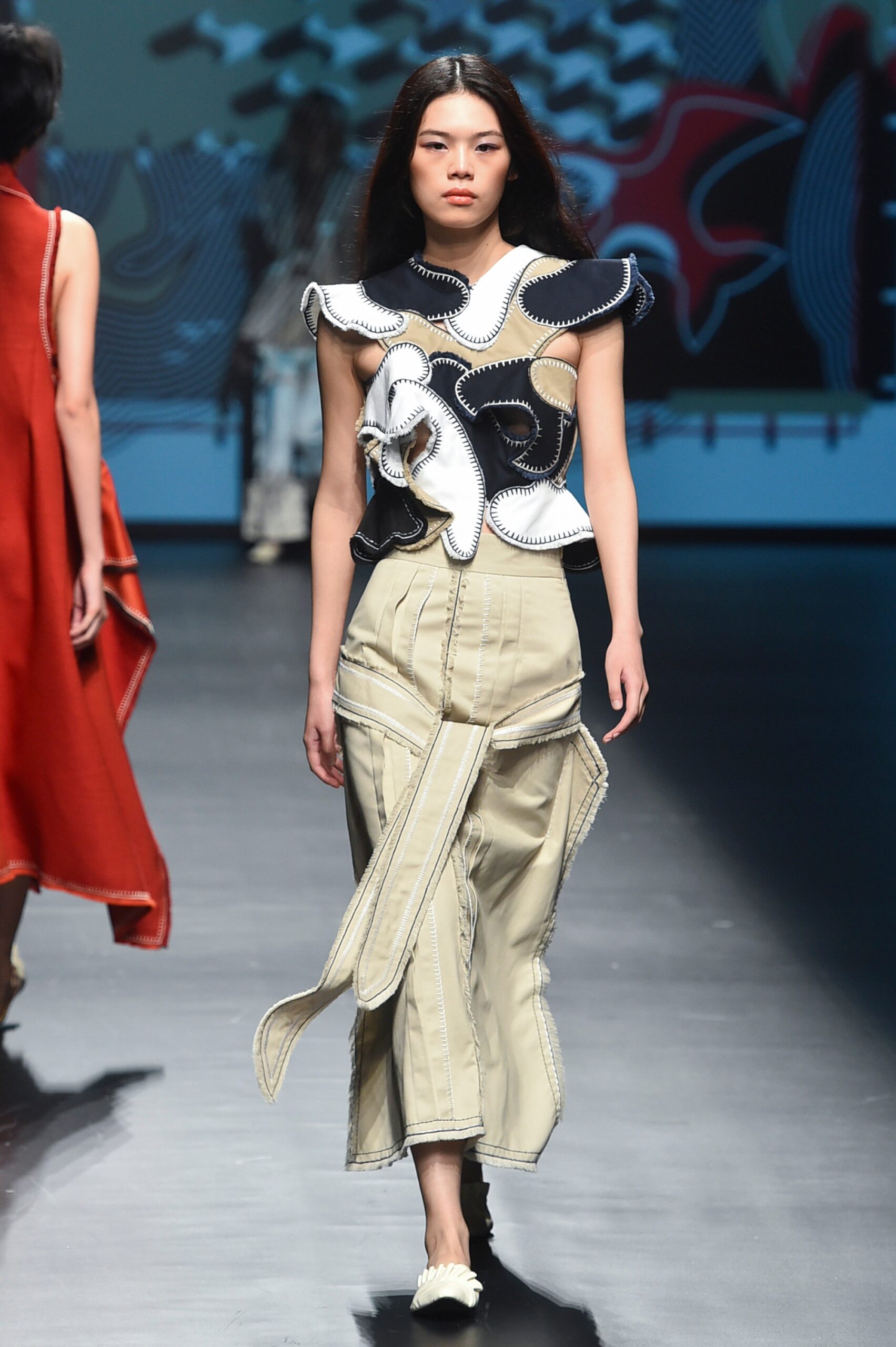 fitted black and white top with tailored beige pants