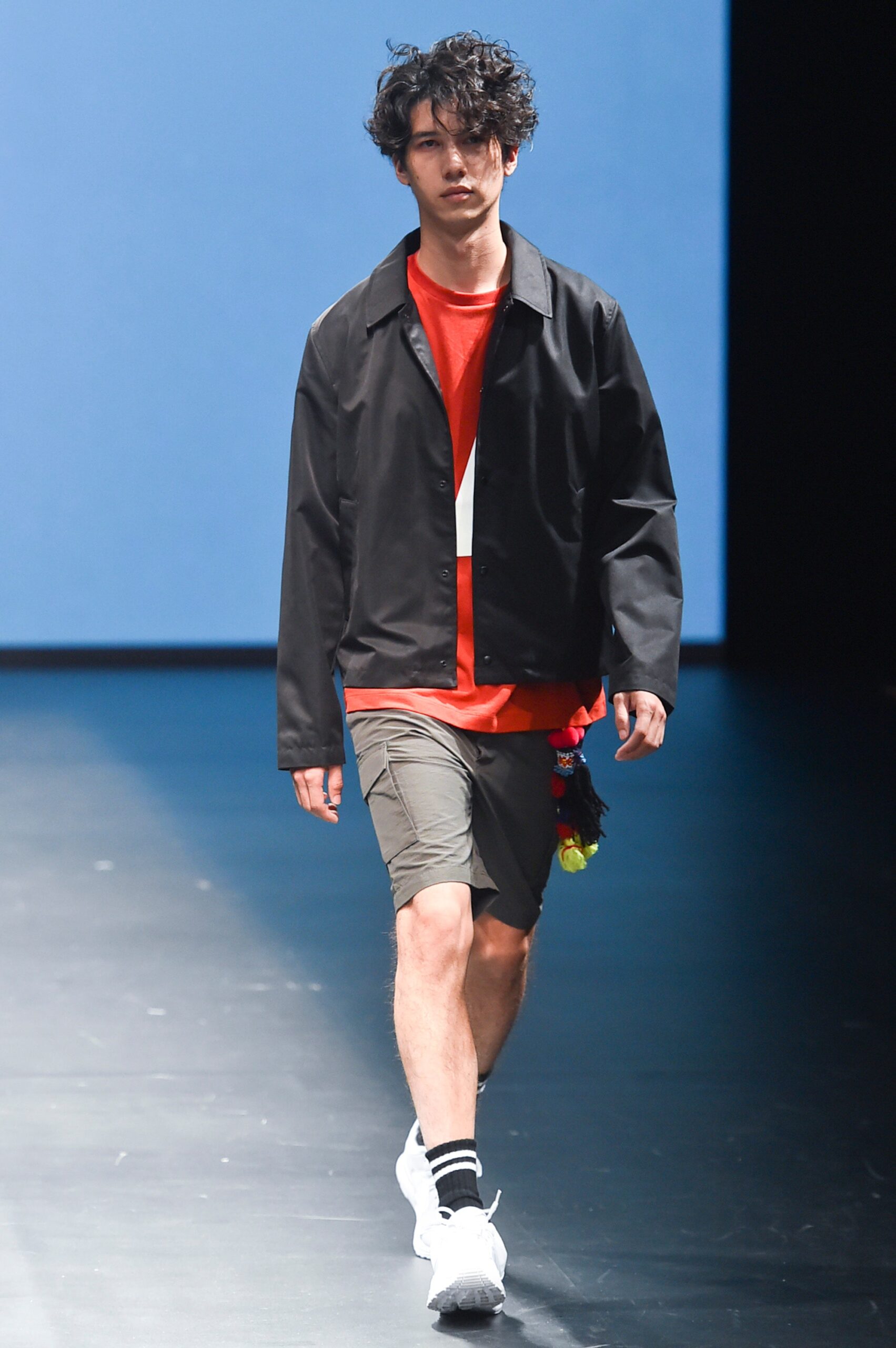 black jacket red t-shirt gray shorts