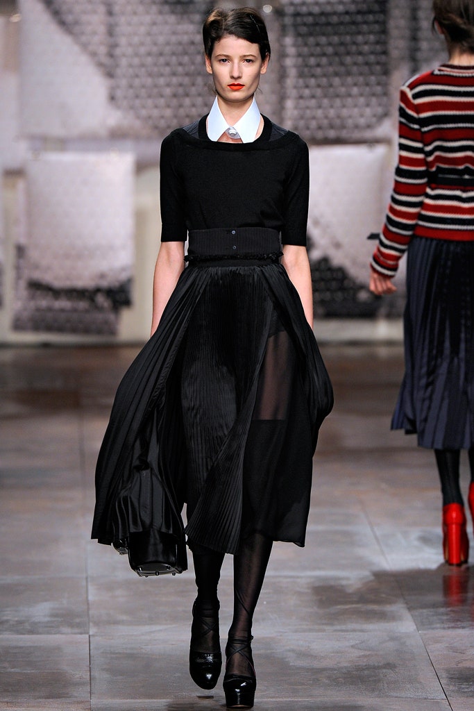 black fitted top and pleated skirt