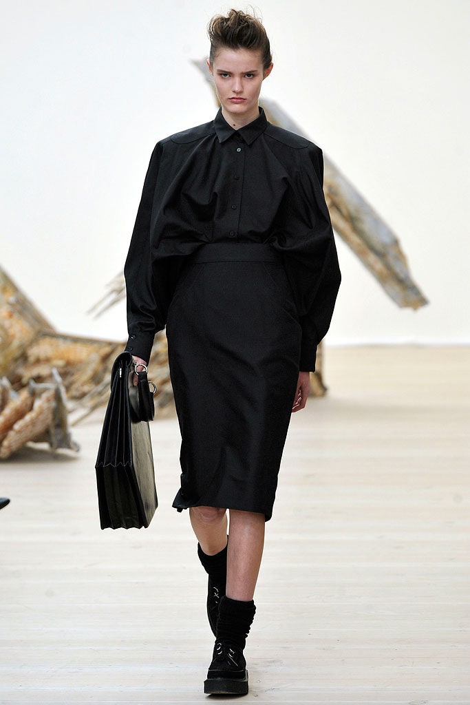 black fitted midi dress with structured bag