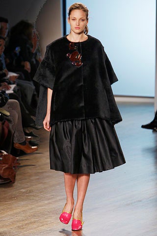 black faux-fur cape and pleated skirt