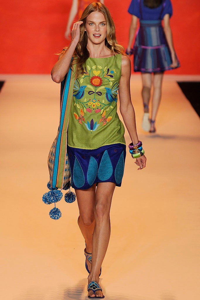green embroidered sleeveless top and blue skirt