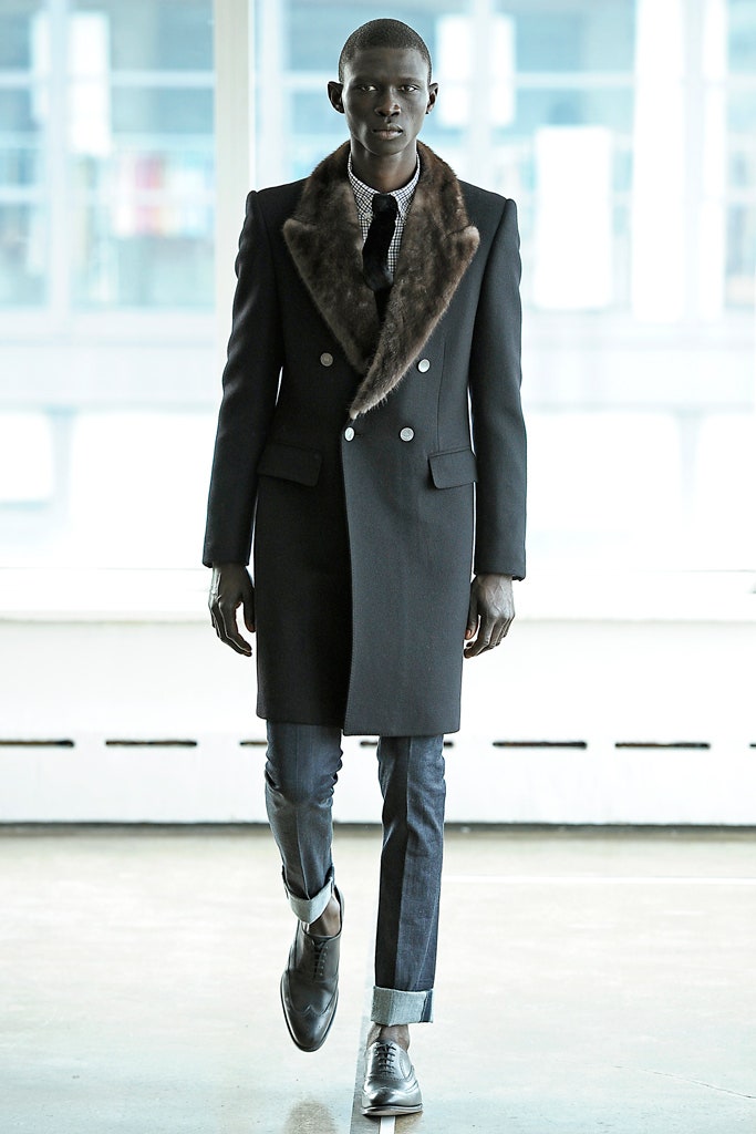 black tailored coat and blue pants
