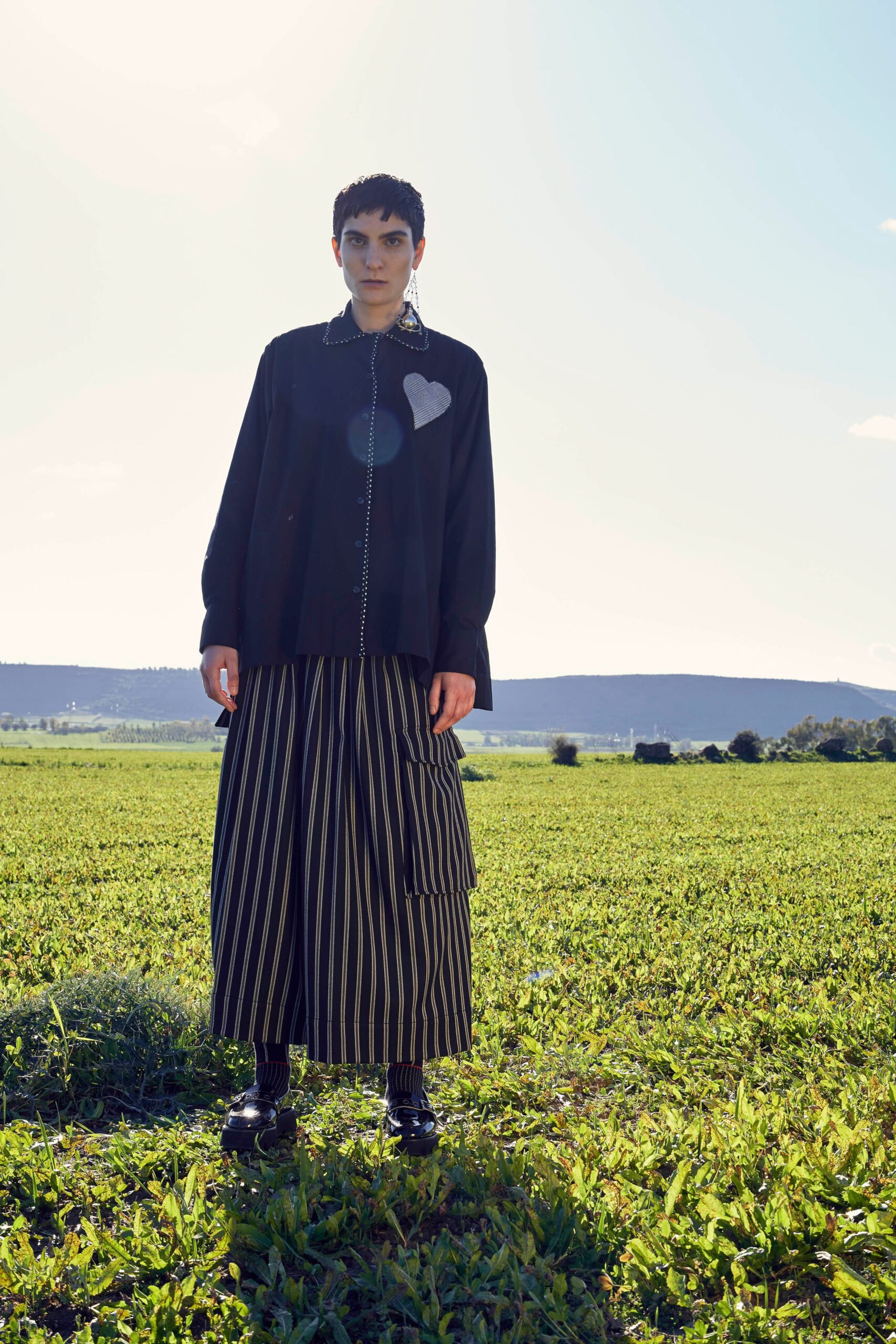 black relaxed shirt with pleated skirt