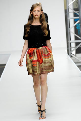 black fitted top with pleated mini skirt