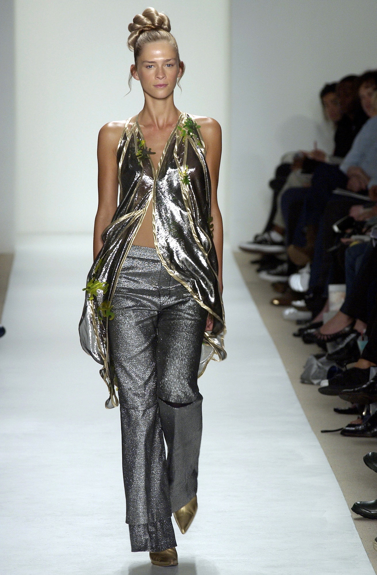 gold draped top with silver flared pants