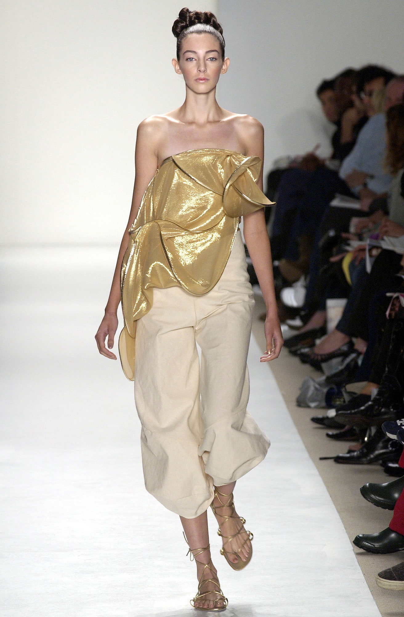 gold draped top with beige pants