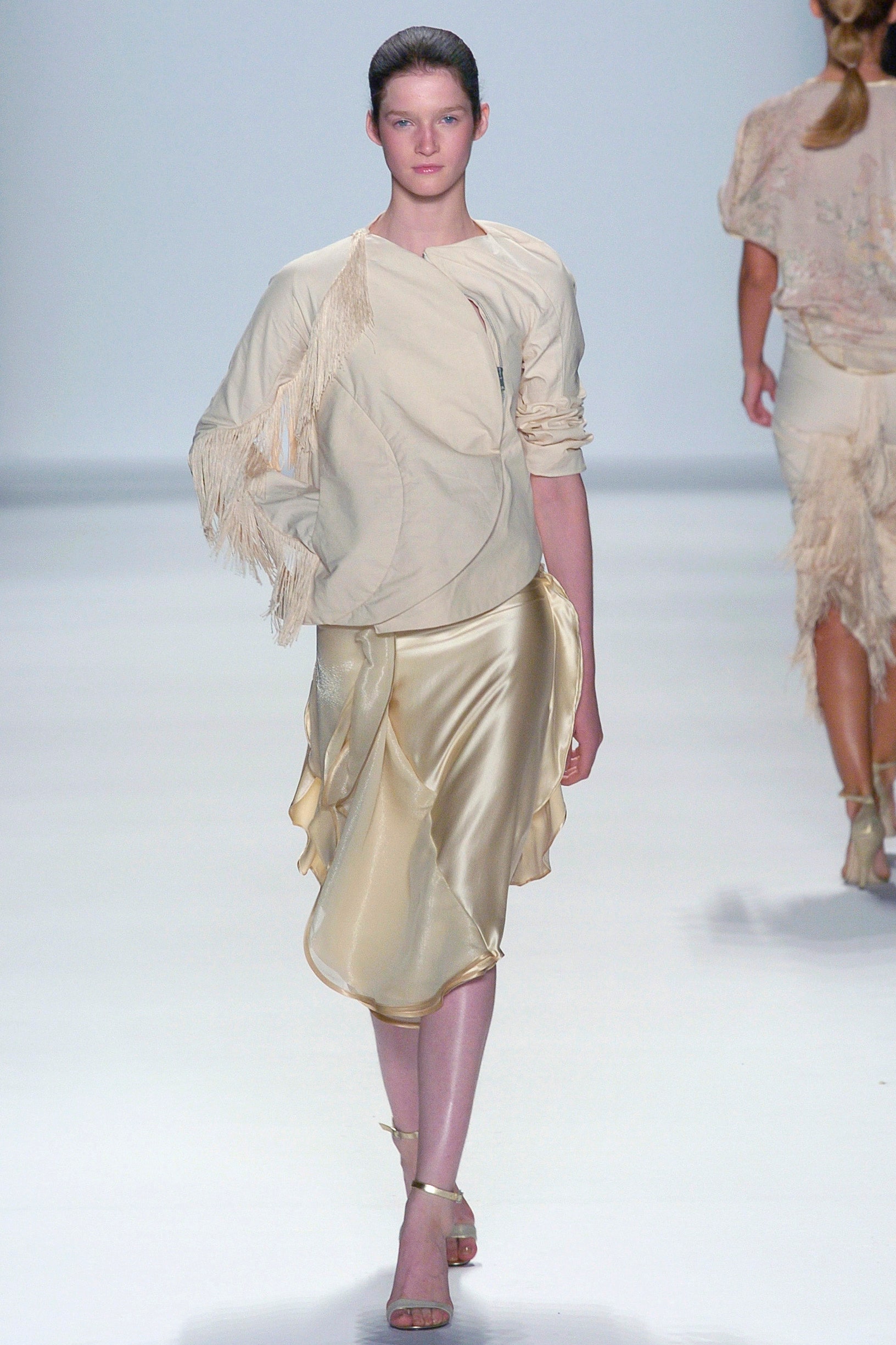 beige silk top with fringe and gold draped skirt