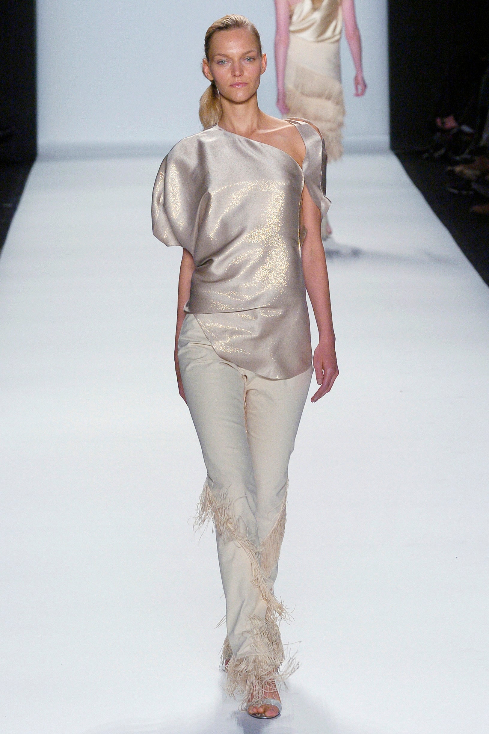 beige silk asymmetric top and white fringed pants