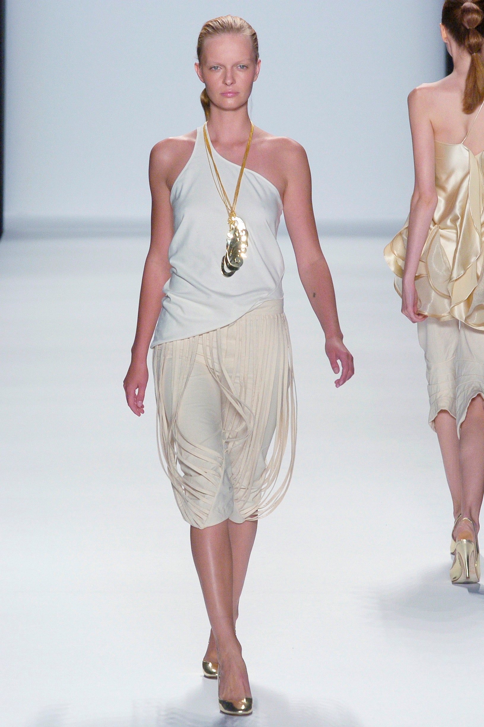 white silk halter top with beige pleated pants