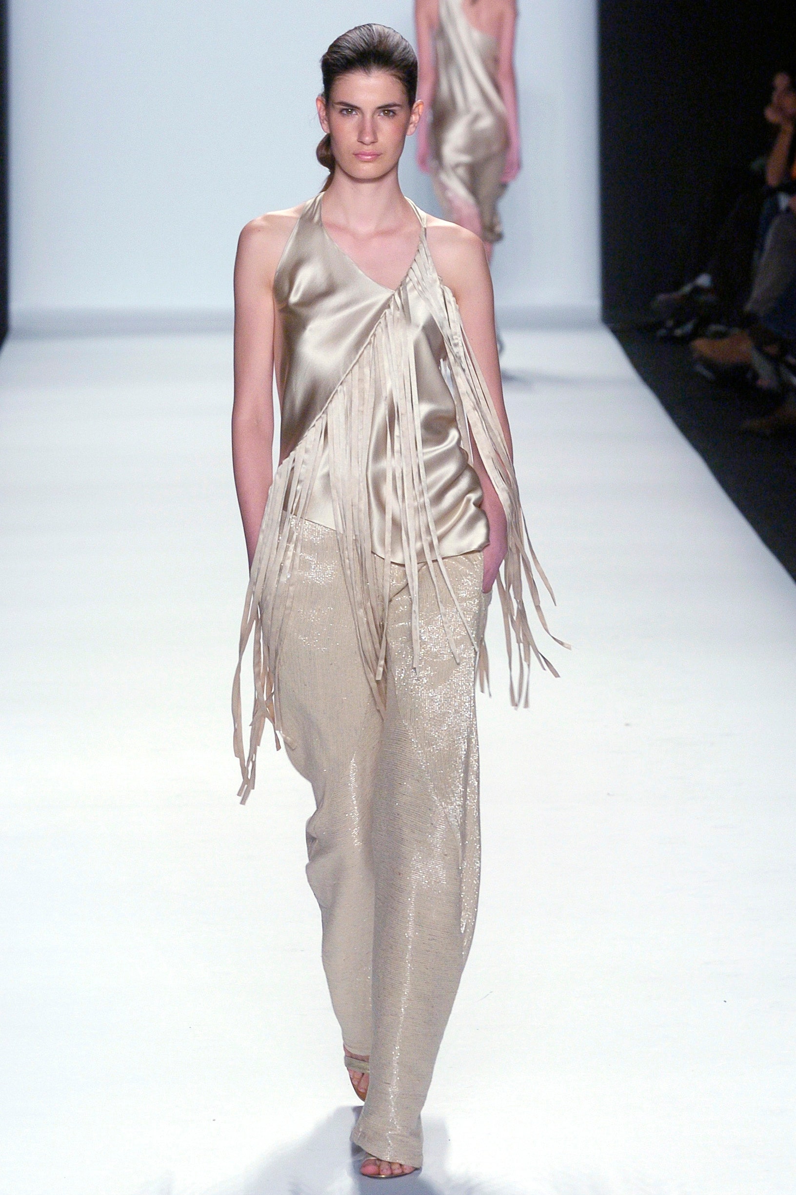 beige asymmetric silk top with gold pants