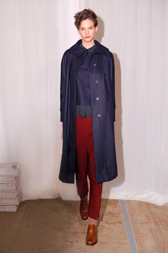 navy coat with black top and red pants
