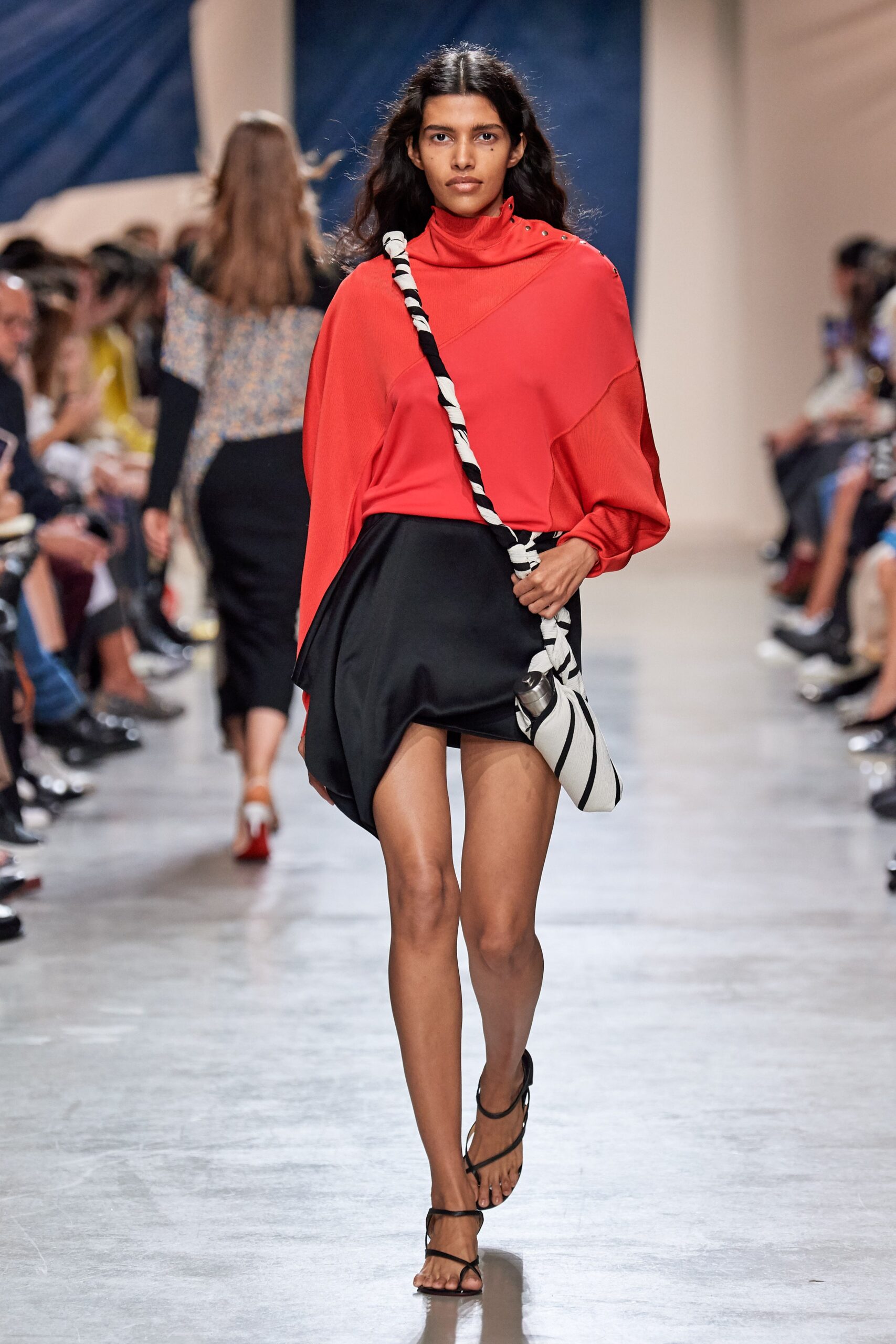 red relaxed top with black skirt
