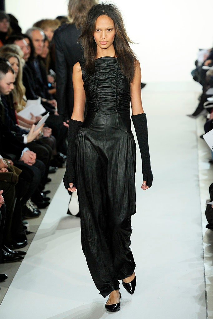 black leather fitted jumpsuit with gloves