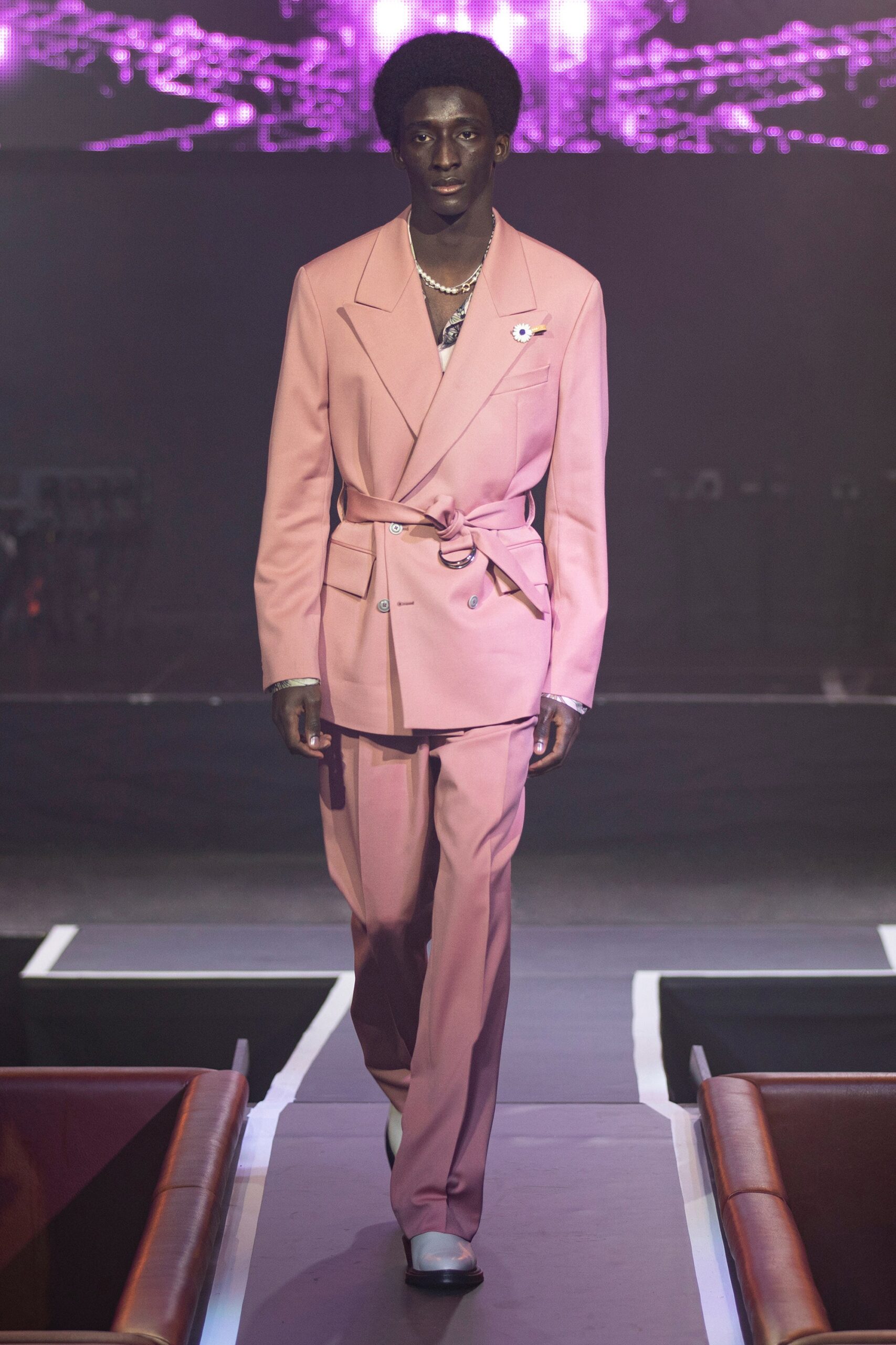 pink tailored suit with white shoes