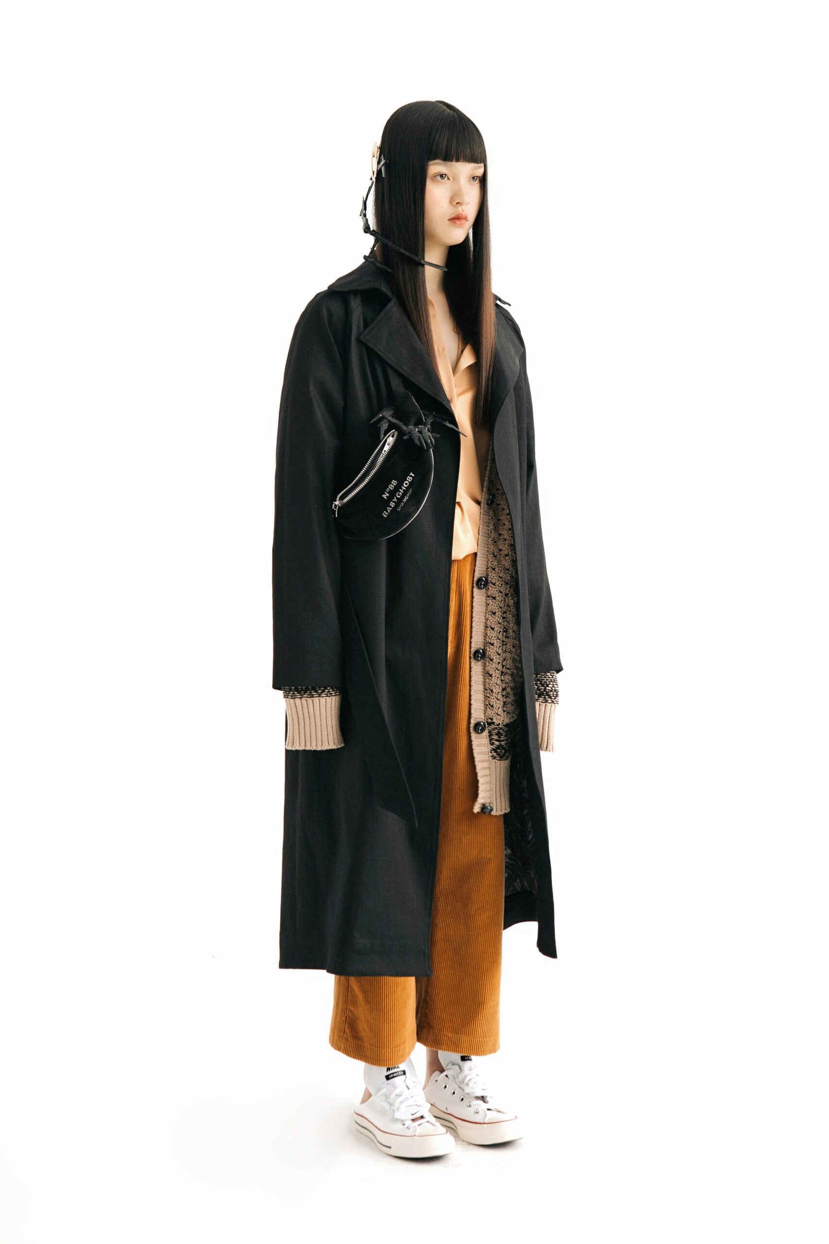 black coat beige top orange pants