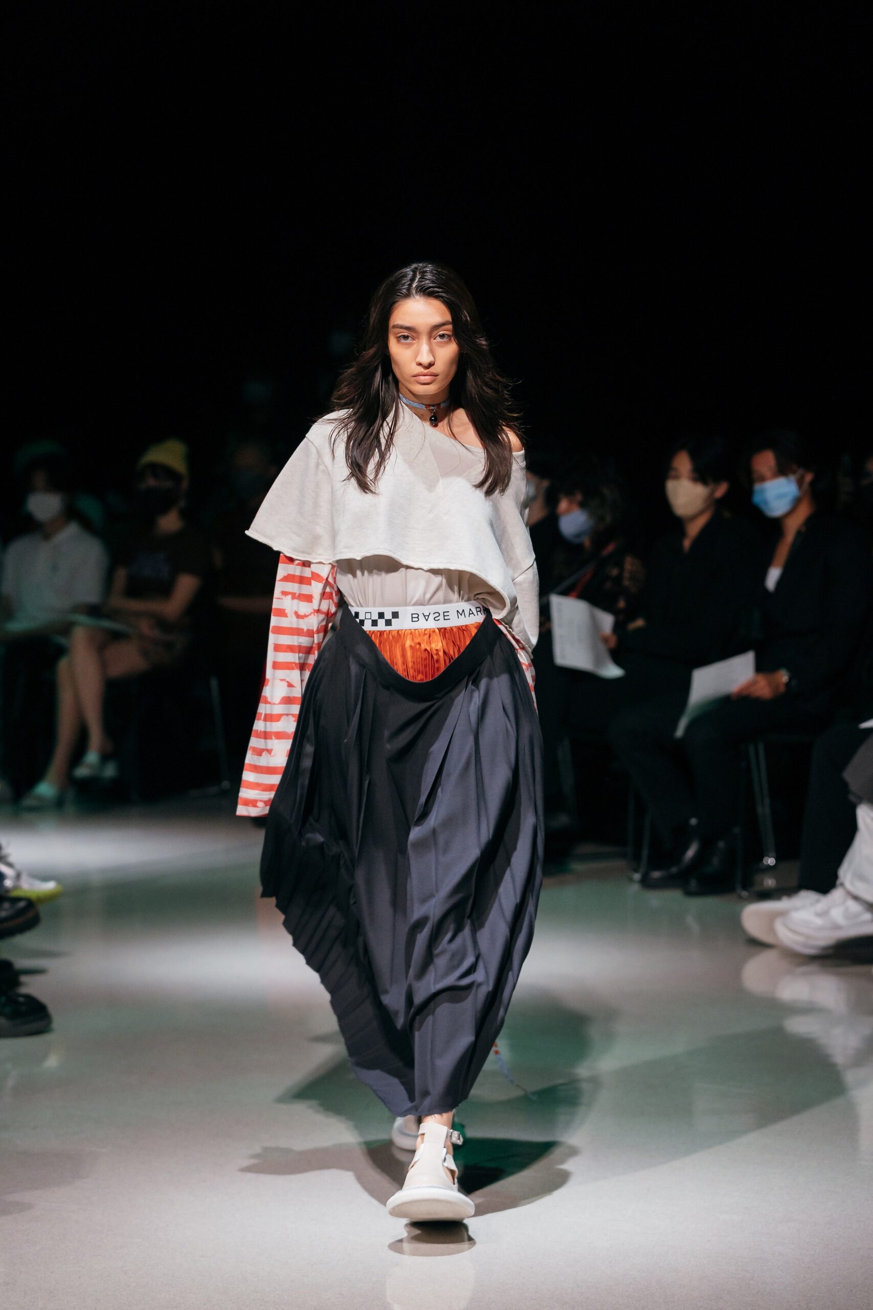 relaxed gray top with pleated black skirt