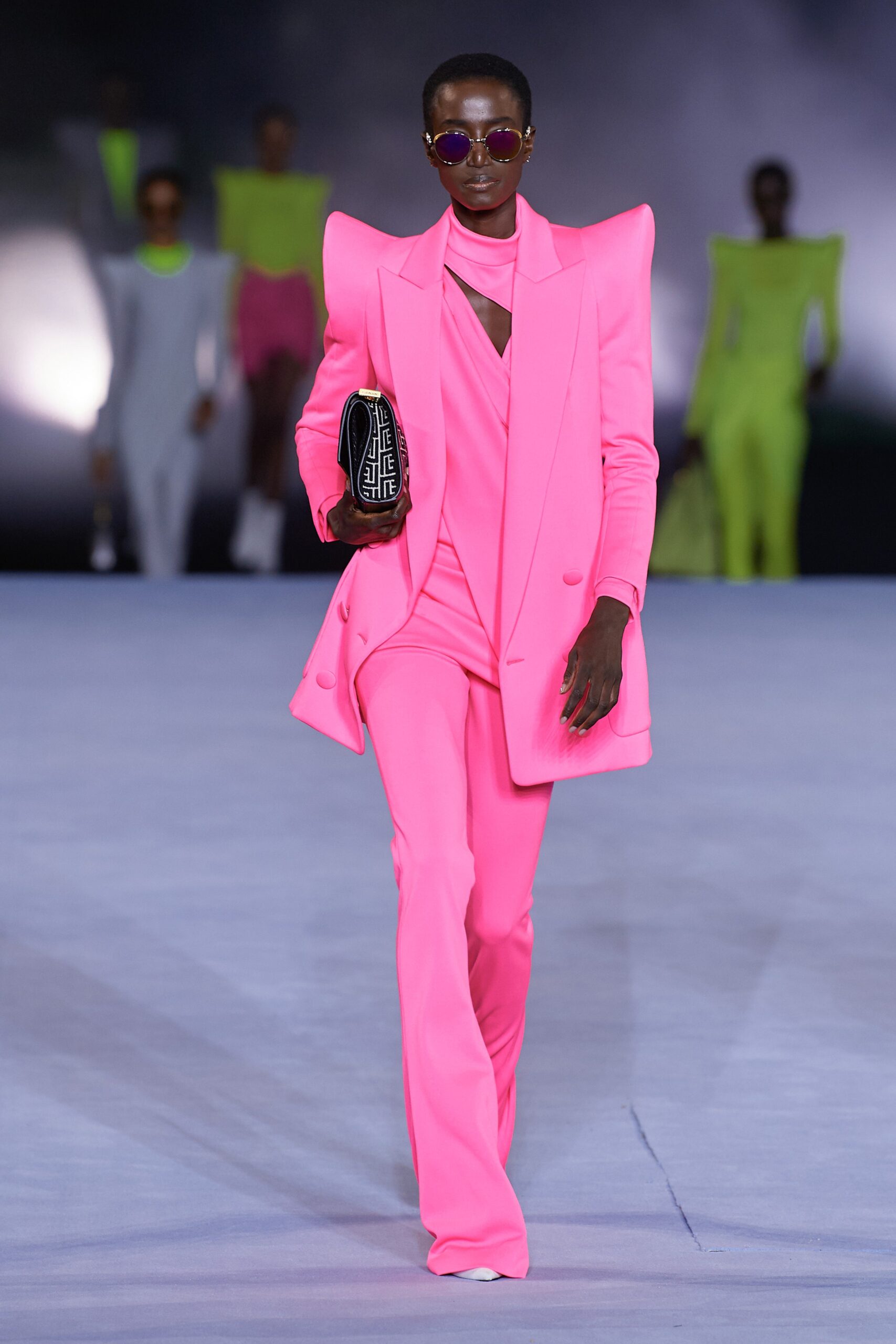 pink fitted suit with clutch