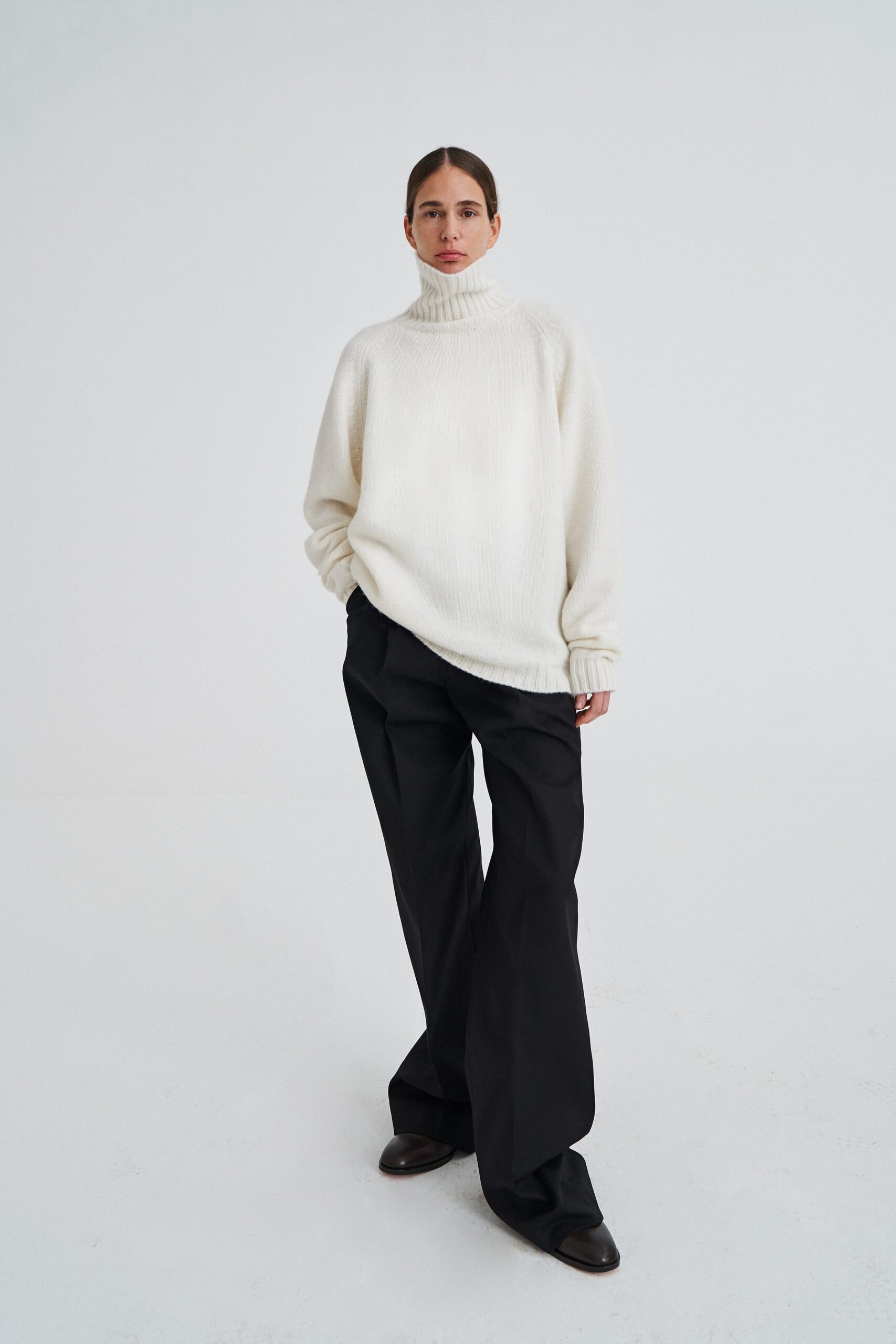 oversized white wool sweater and black pants