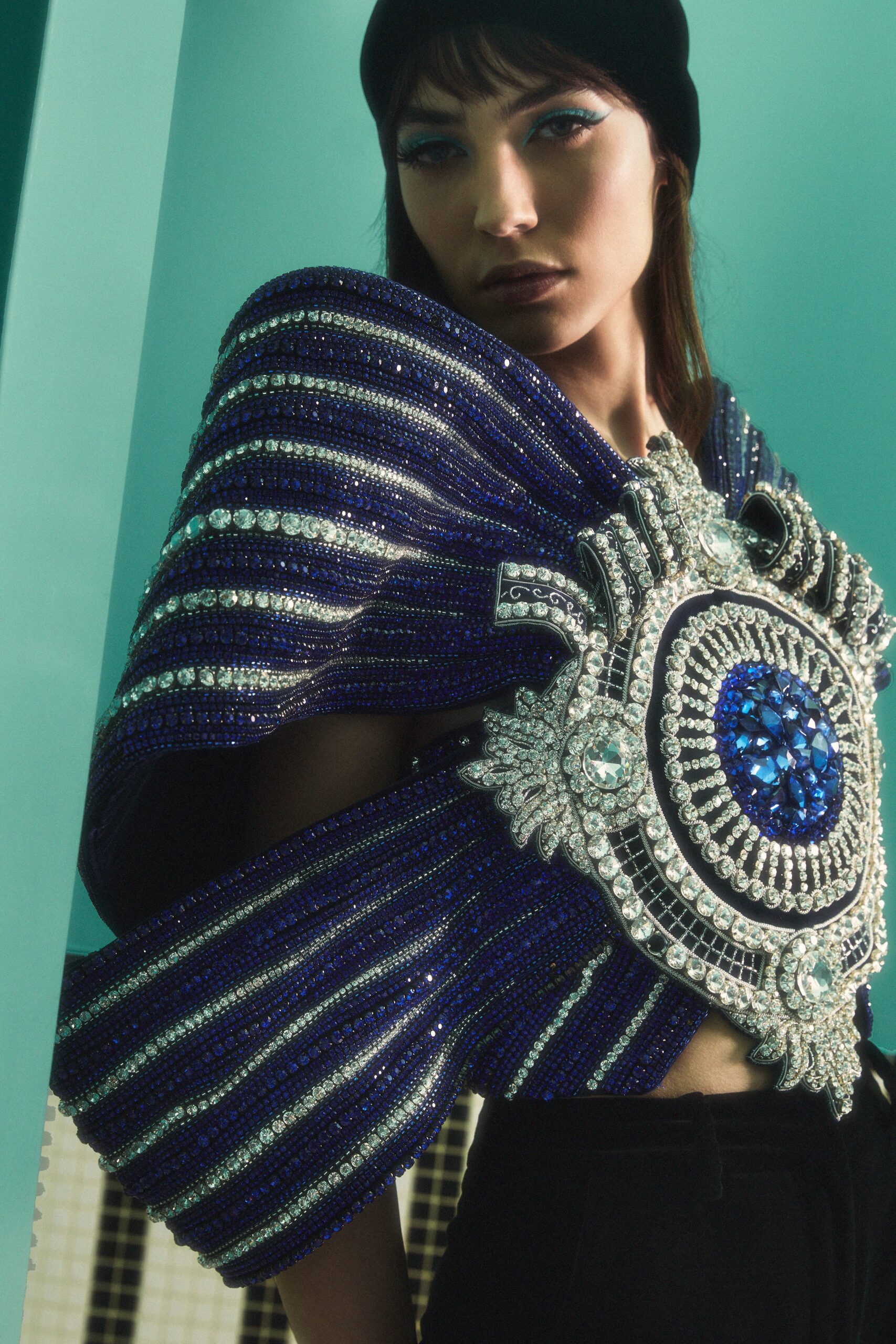 blue embellished cape with black pants