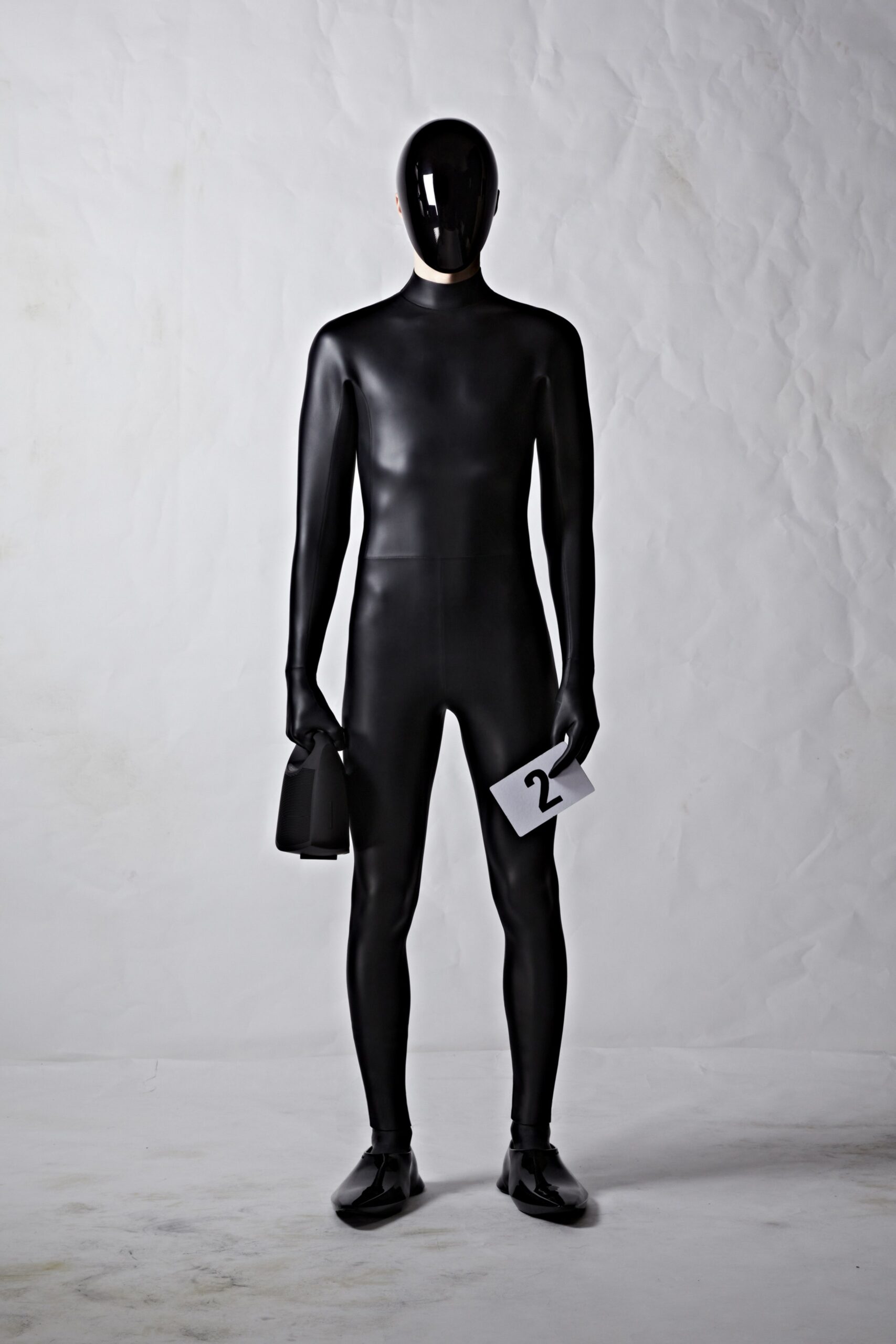 black fitted vinyl catsuit