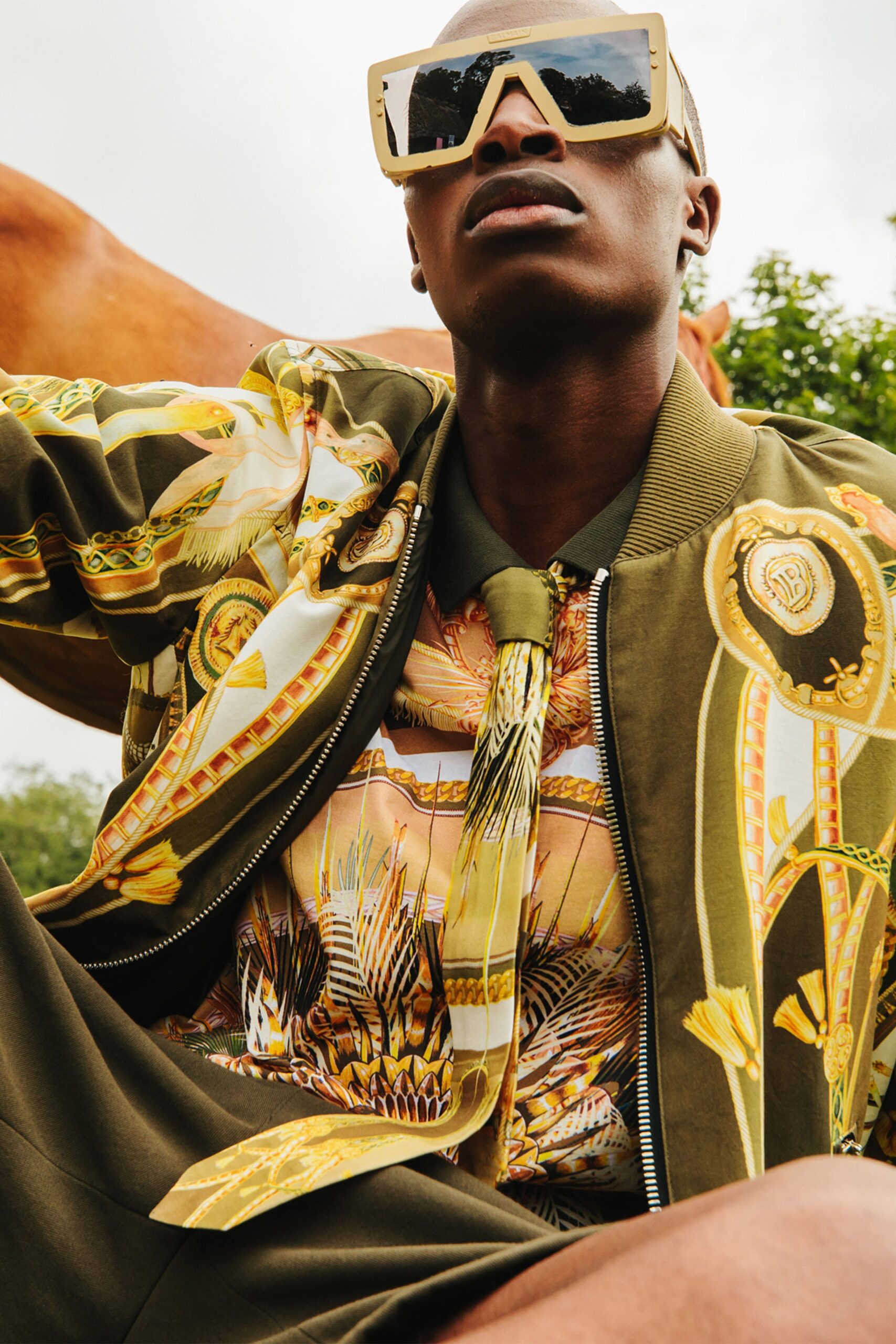green printed jacket with sunglasses