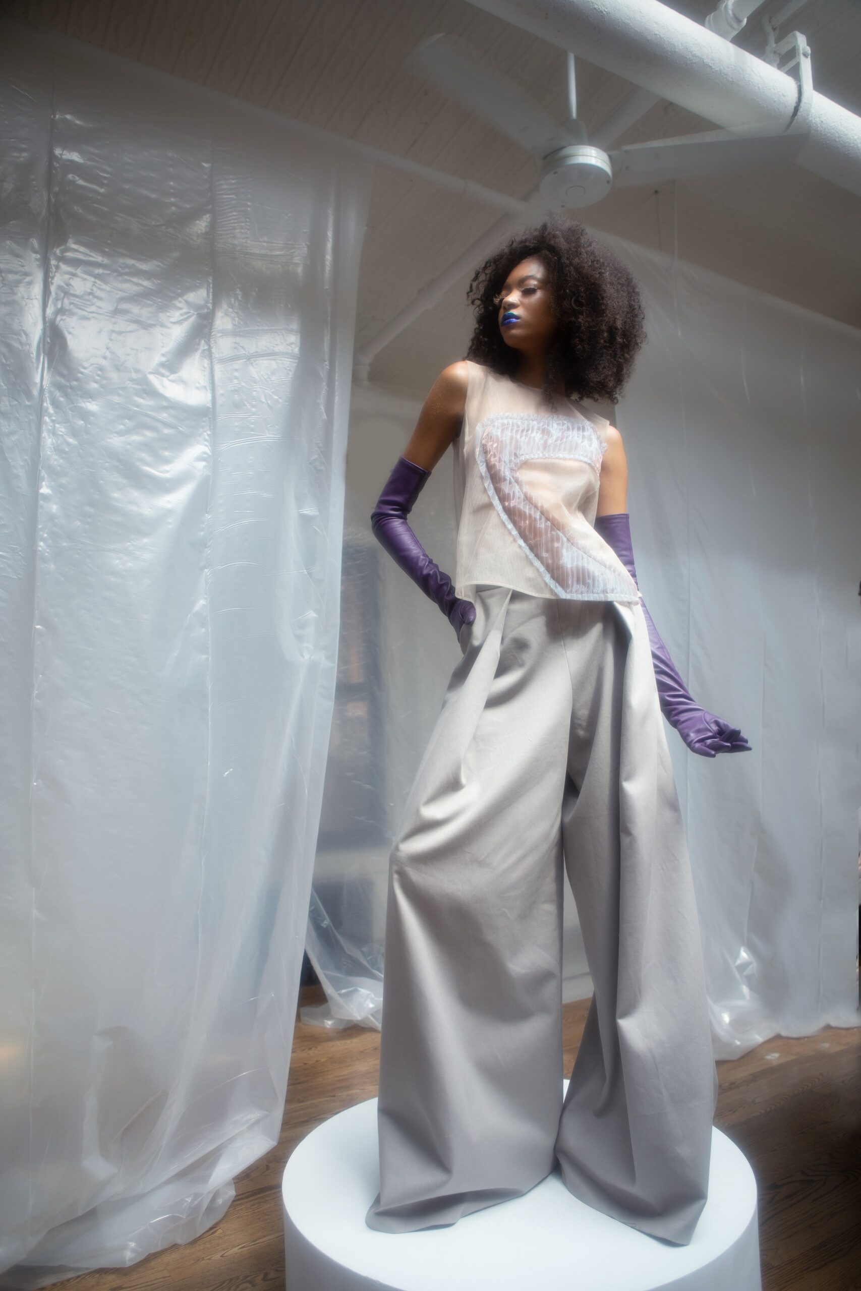 white silk fitted top with gray wide-leg pants