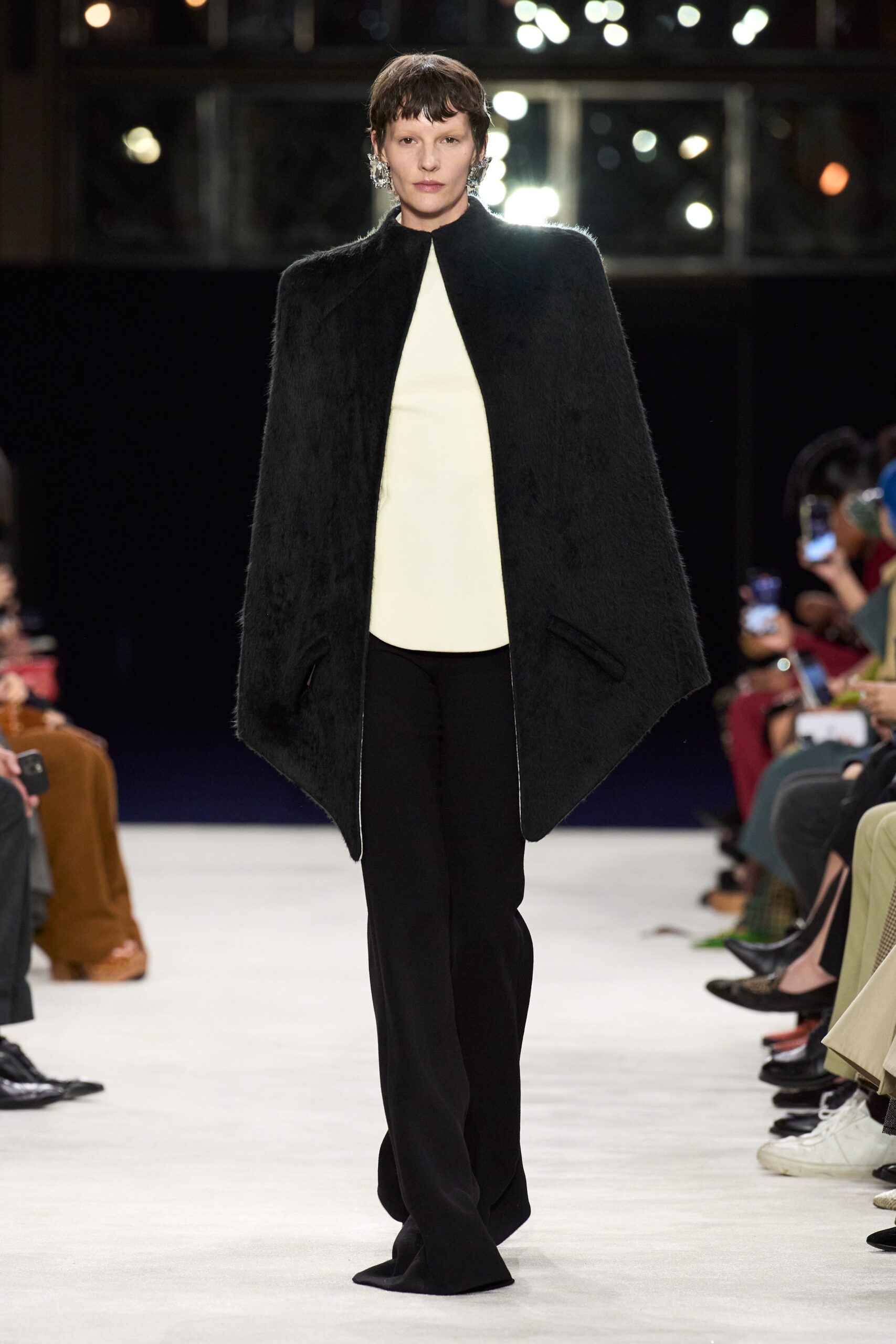 black fur cape white silk top black tailored pants