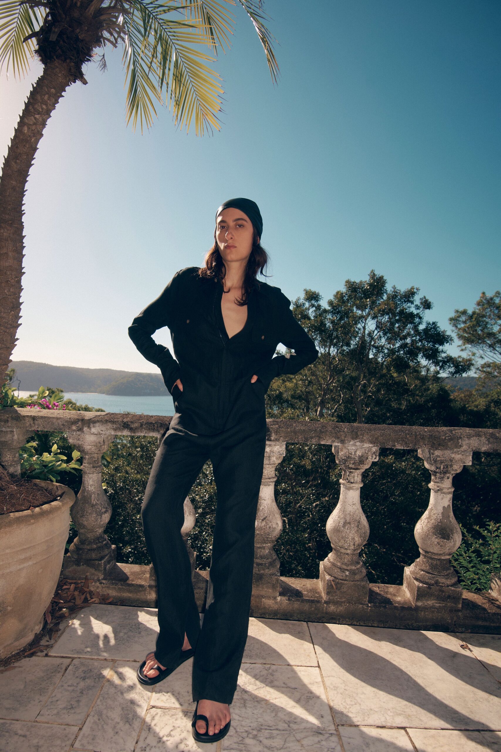 black fitted jumpsuit with flat shoes