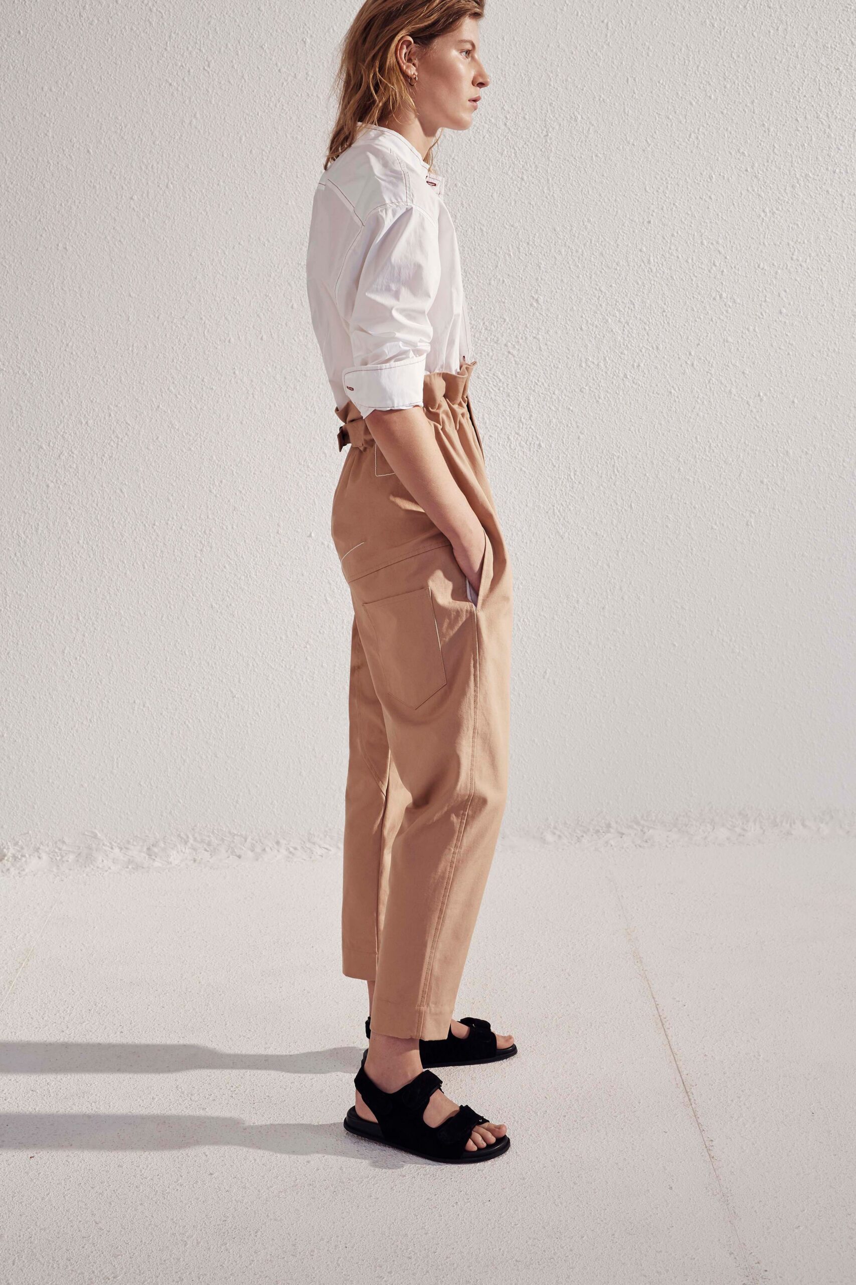 white relaxed shirt with beige pants