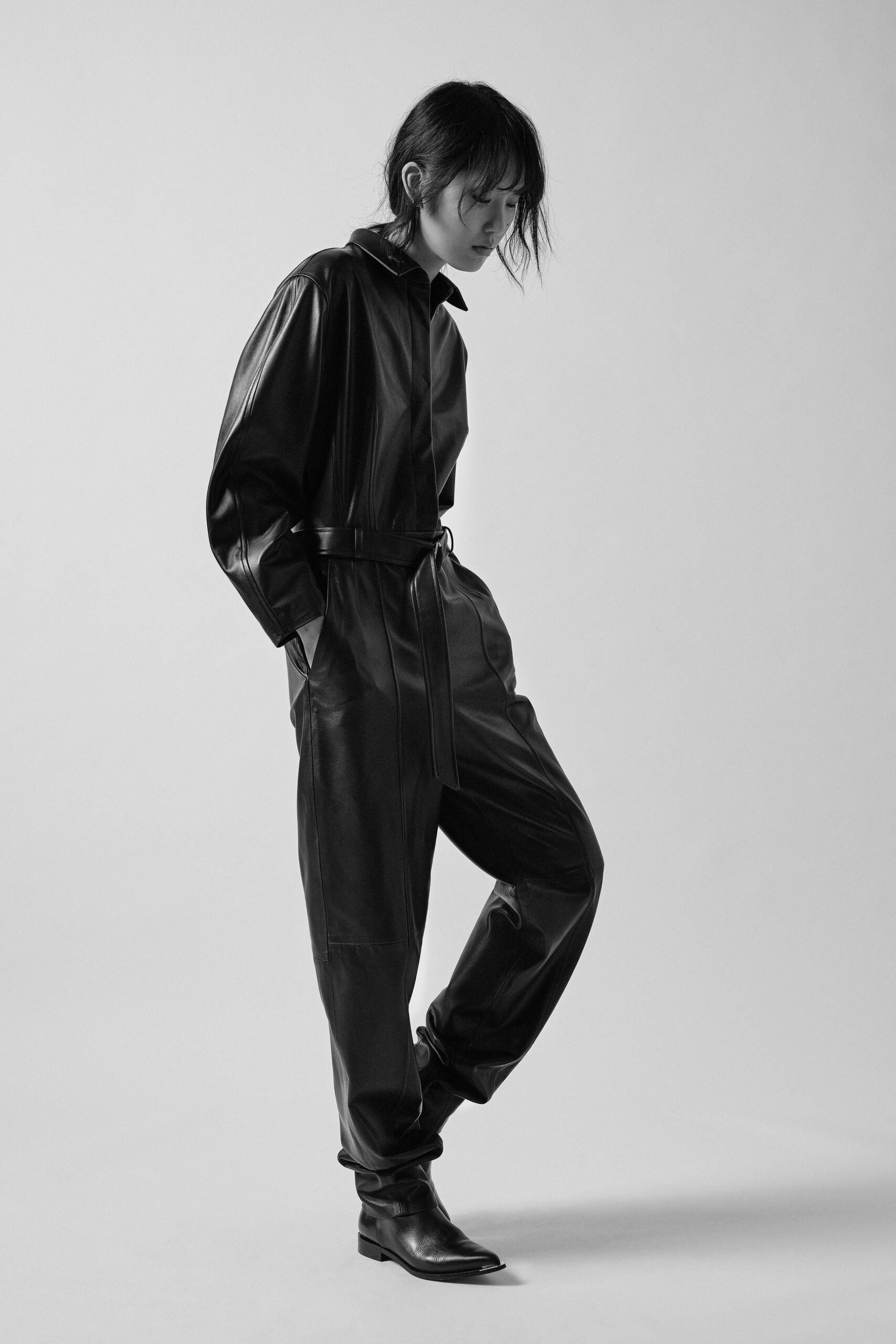 black leather fitted jumpsuit with boots