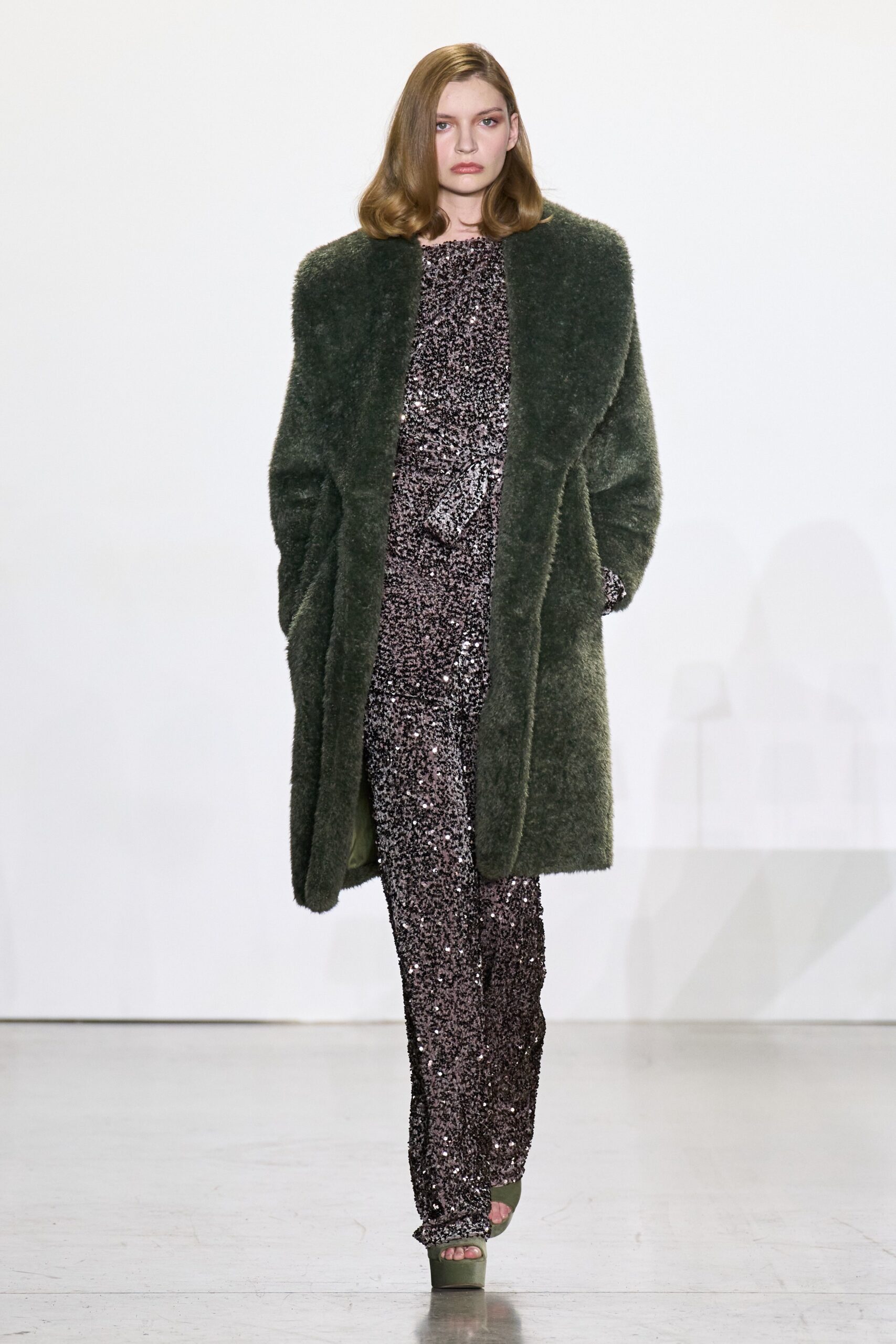 green faux-fur coat and purple sequin jumpsuit