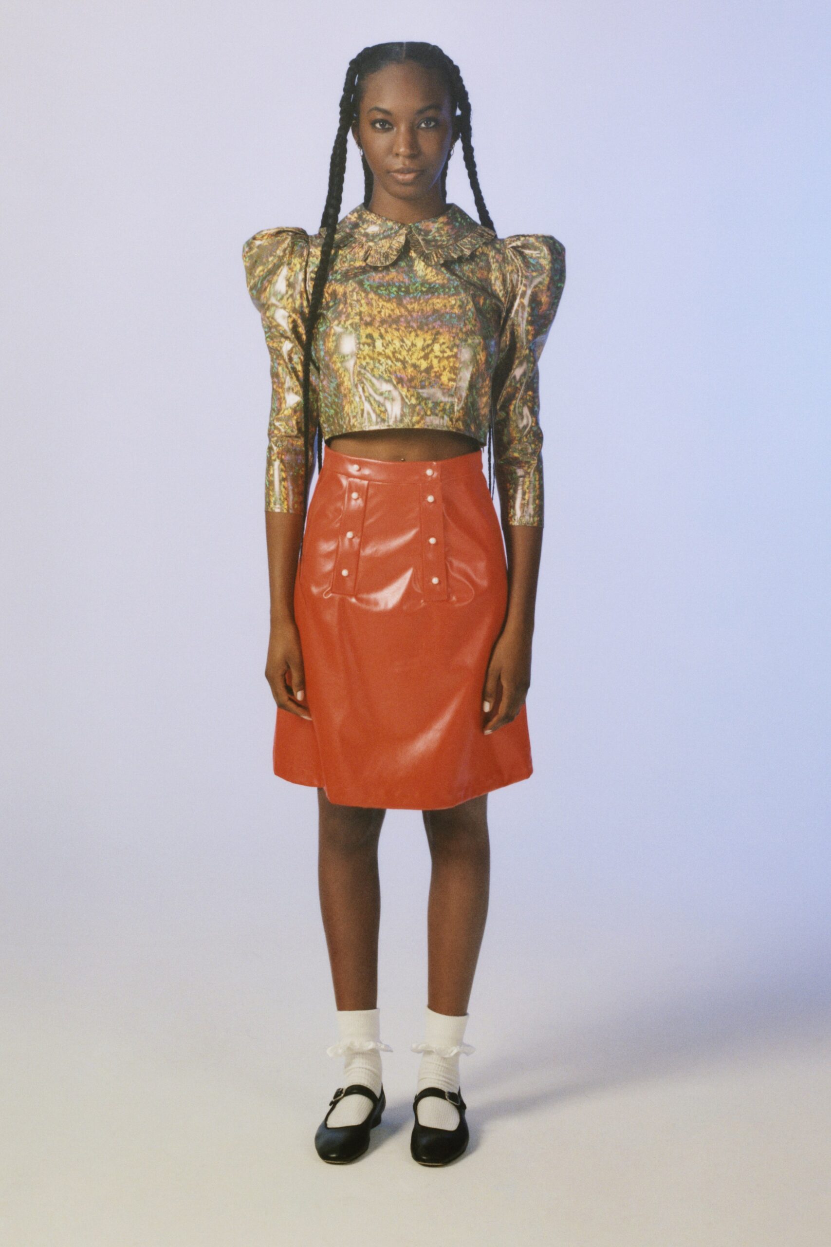 multi-colored fitted top with red vinyl skirt