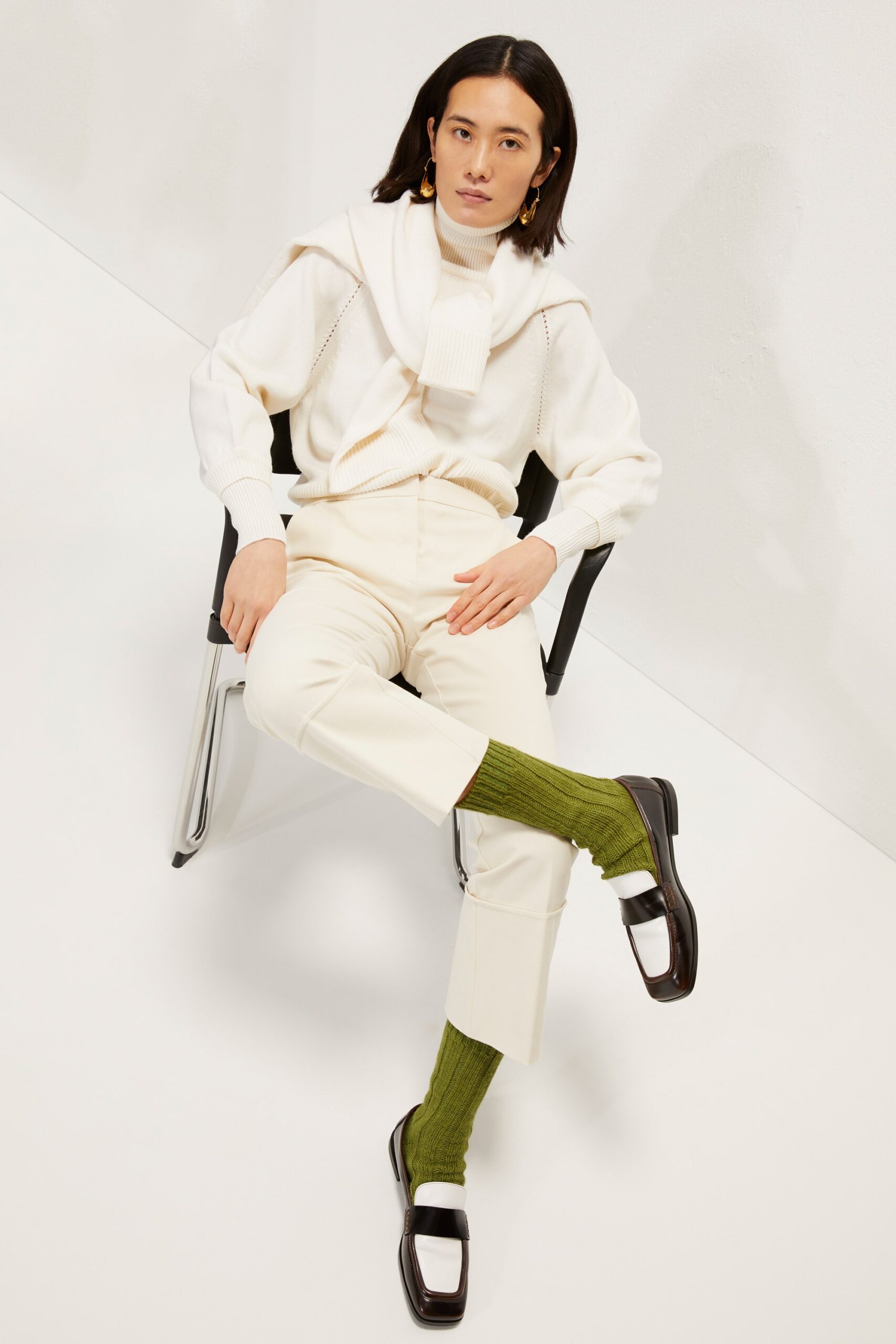 white fitted sweater with beige pants